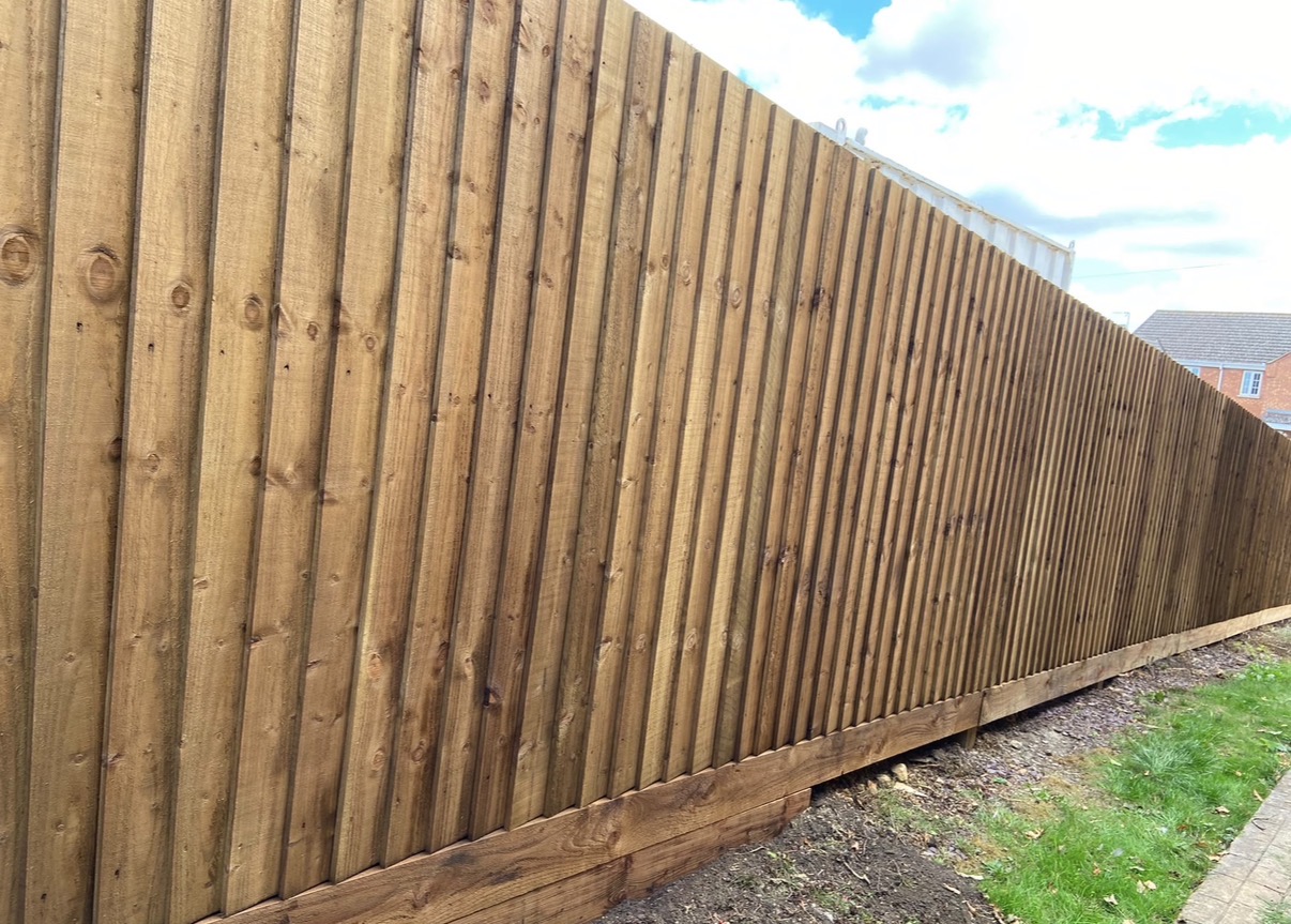 Finished timber fence professionally sprayed in a warm brown finish