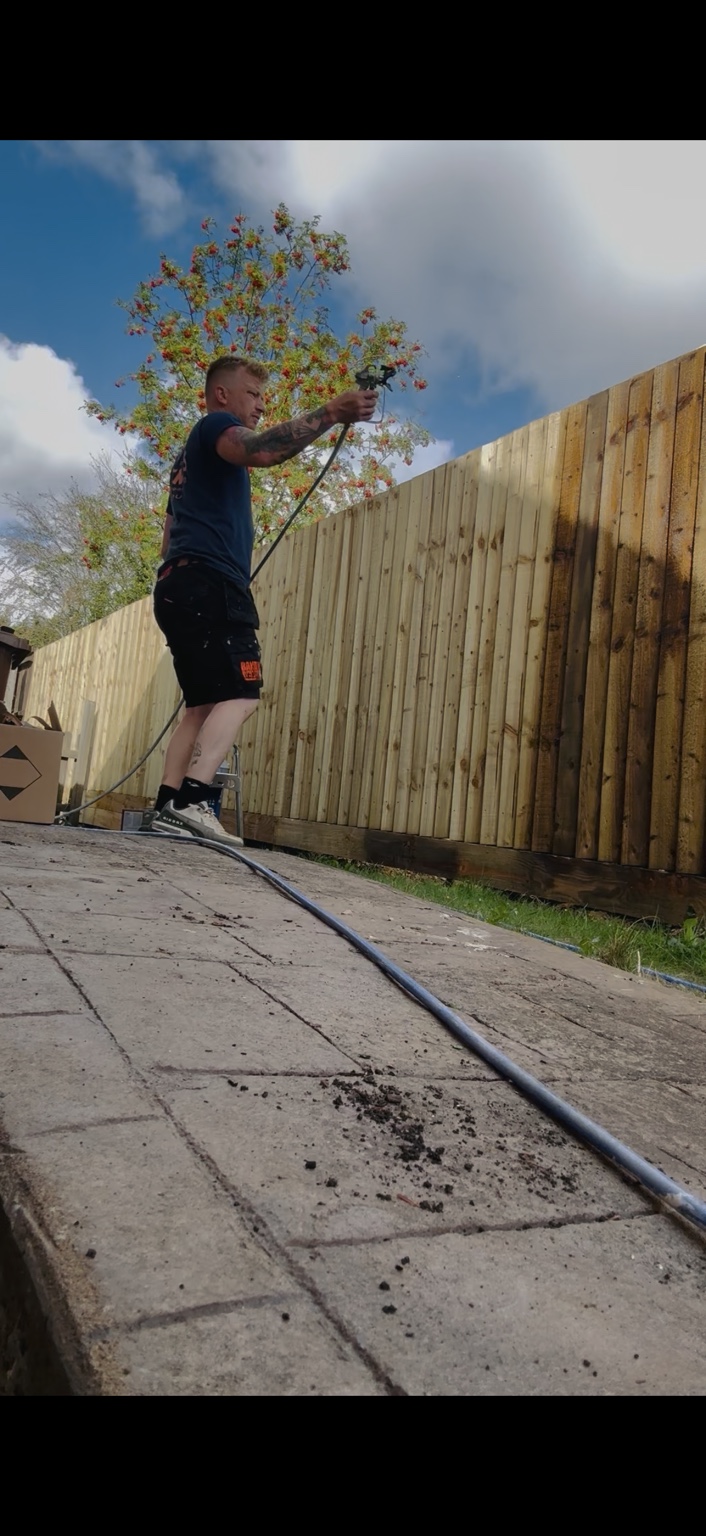 A Sleaford Spray professional spraying a garden fence